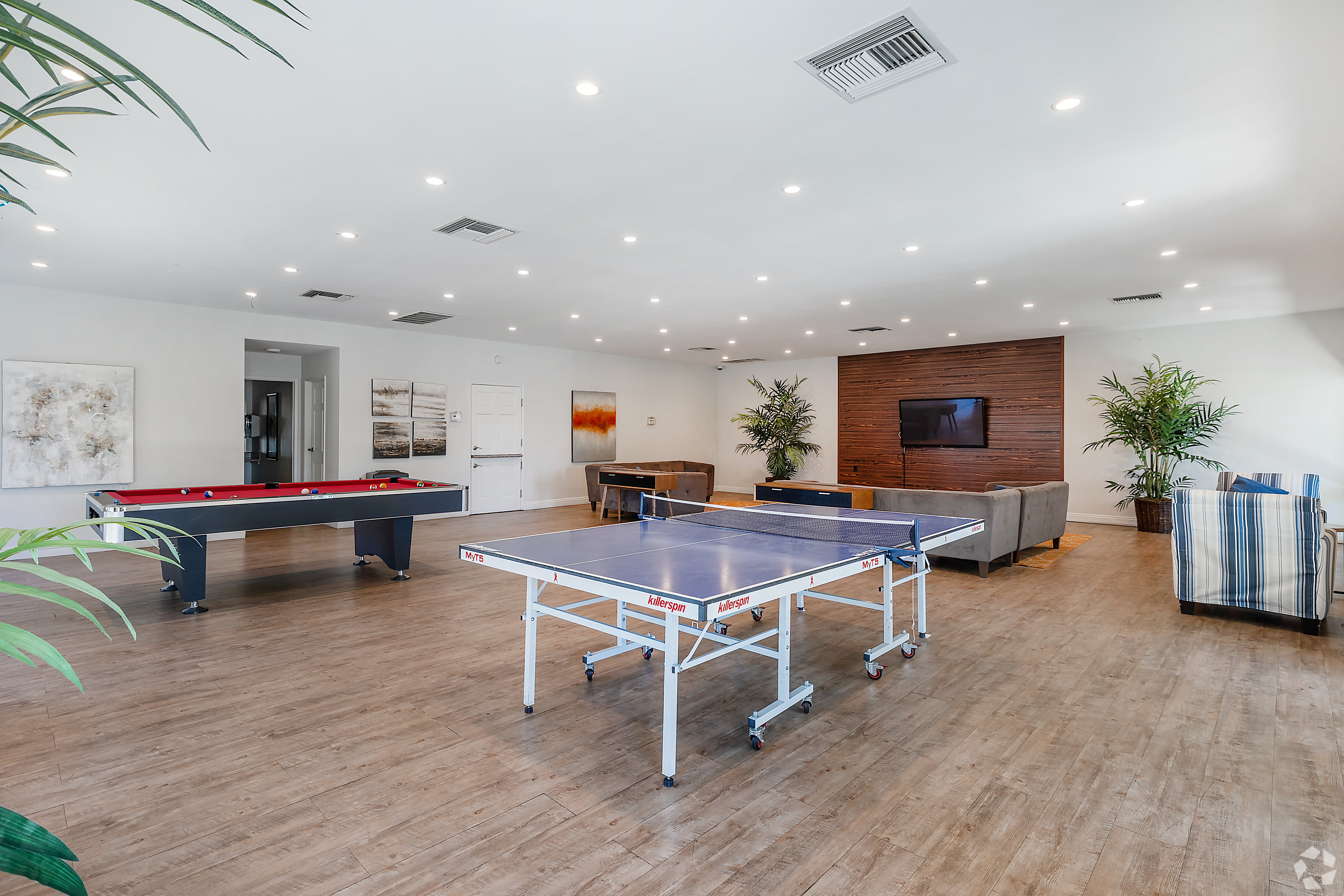 Game room with ping pong, pool table, seating area, and decor at Beck Park in North Hollywood, California