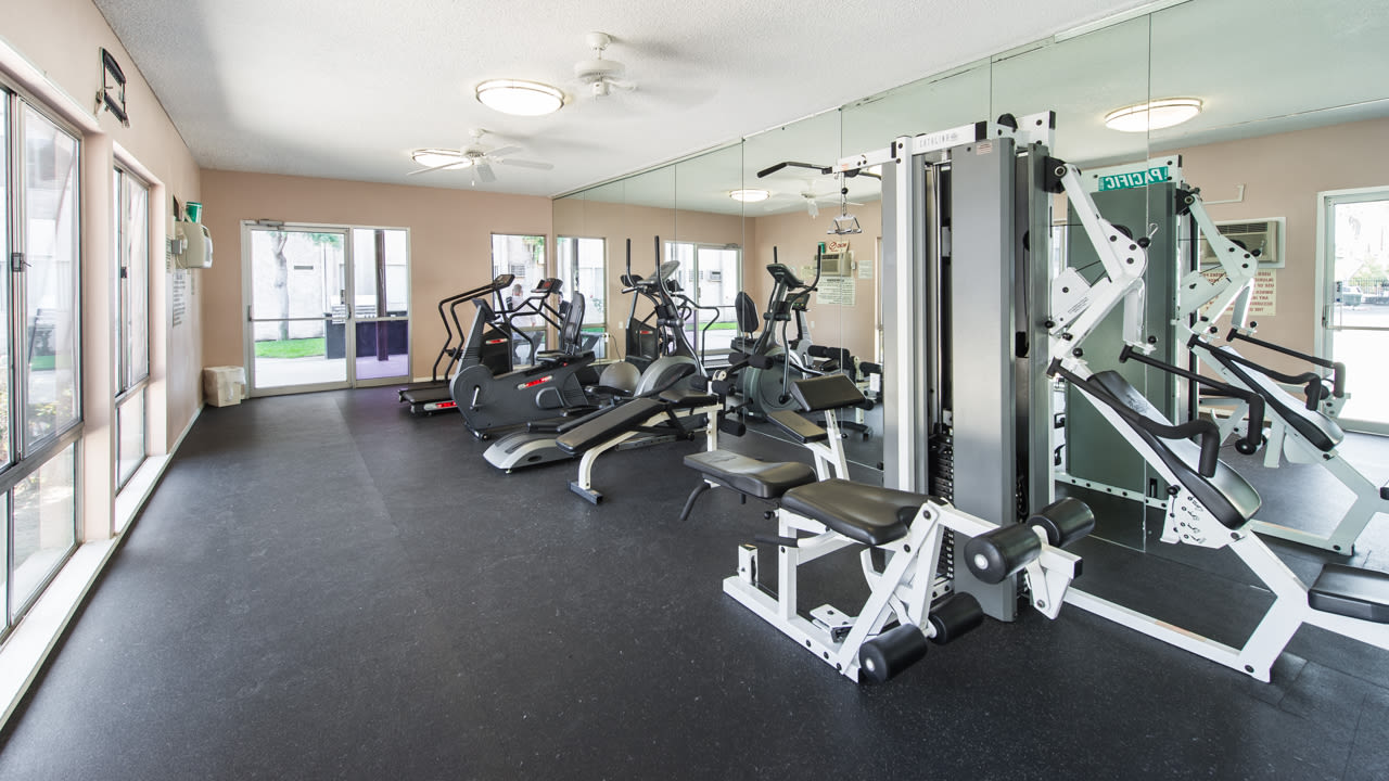 Fitness room with cardio machines and strength equipment at Beck Park in North Hollywood, California