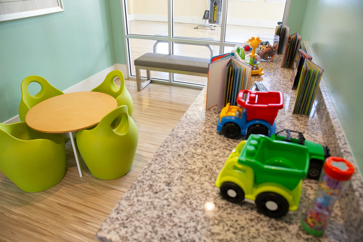 Kids' Kave indoor play area at Keystone at Mebane Oaks clubhouse, with table and toys