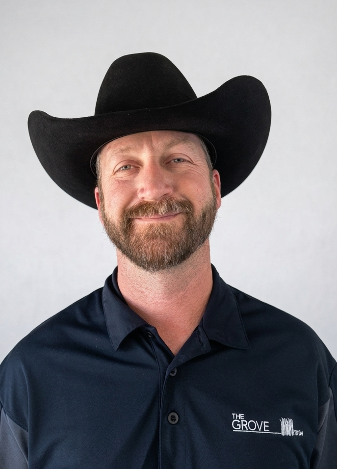 Team member headshot wearing black cowboy hat and branded polo at ATX Fenton in Austin, Texas