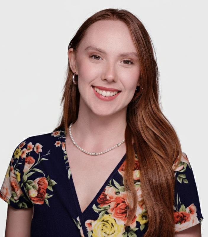 Team member headshot in floral dress and pearl necklace at ATX Fenton in Austin, Texas