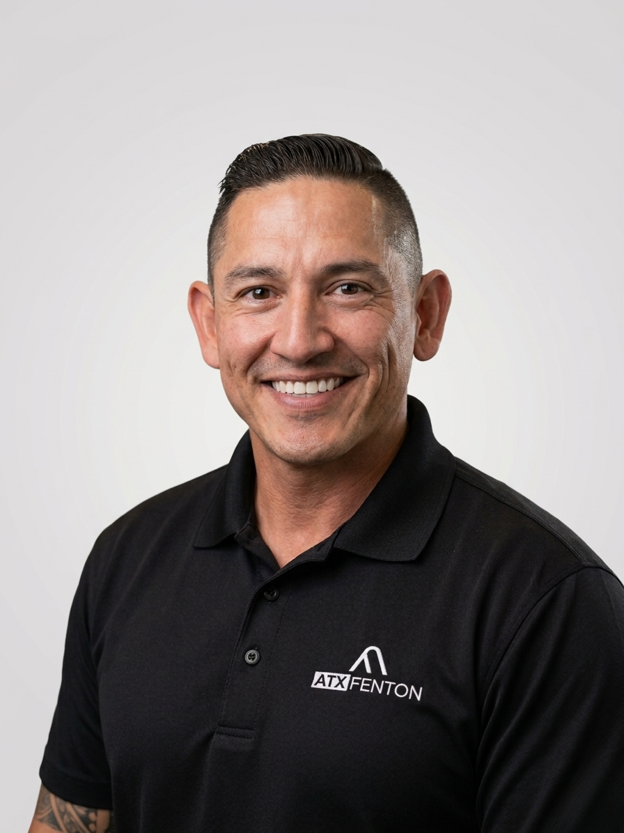 ATX Fenton employee in black logo polo, studio headshot at ATX Fenton in Austin, Texas