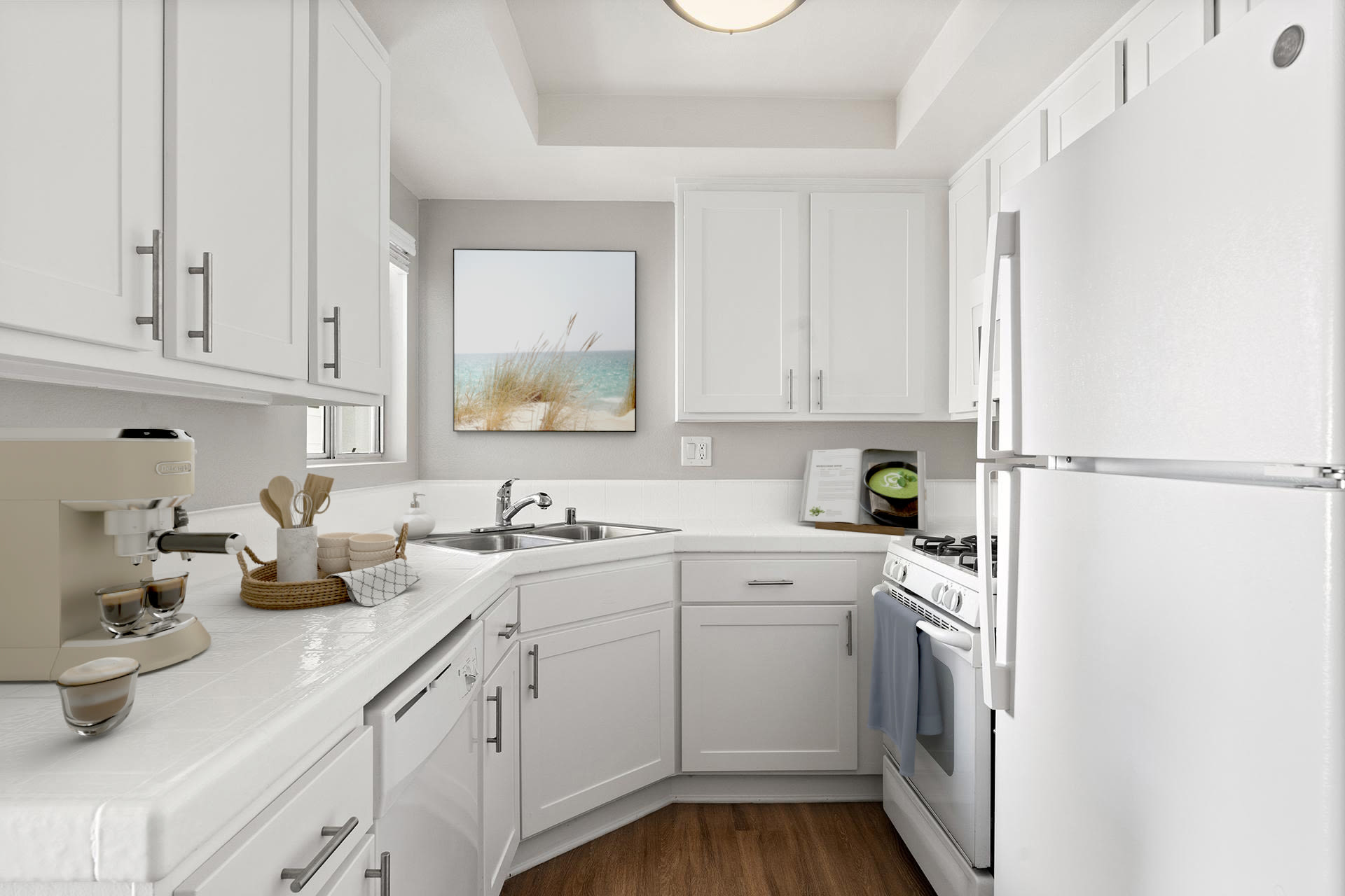 White kitchen with modern appliances and ample counter space at Colony Parc in Ventura, California