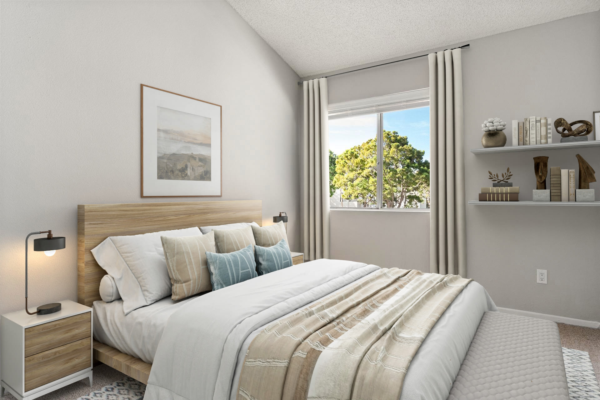 Cozy bedroom with queen bed, neutral decor, and window light at Colony Parc in Ventura, California