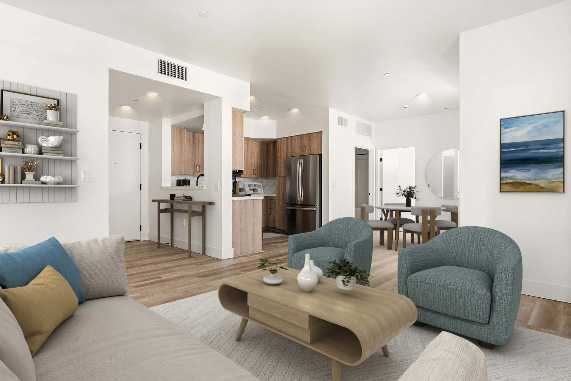 Spacious living room with seating, coffee table, and open kitchen view at Colony Parc in Ventura, California