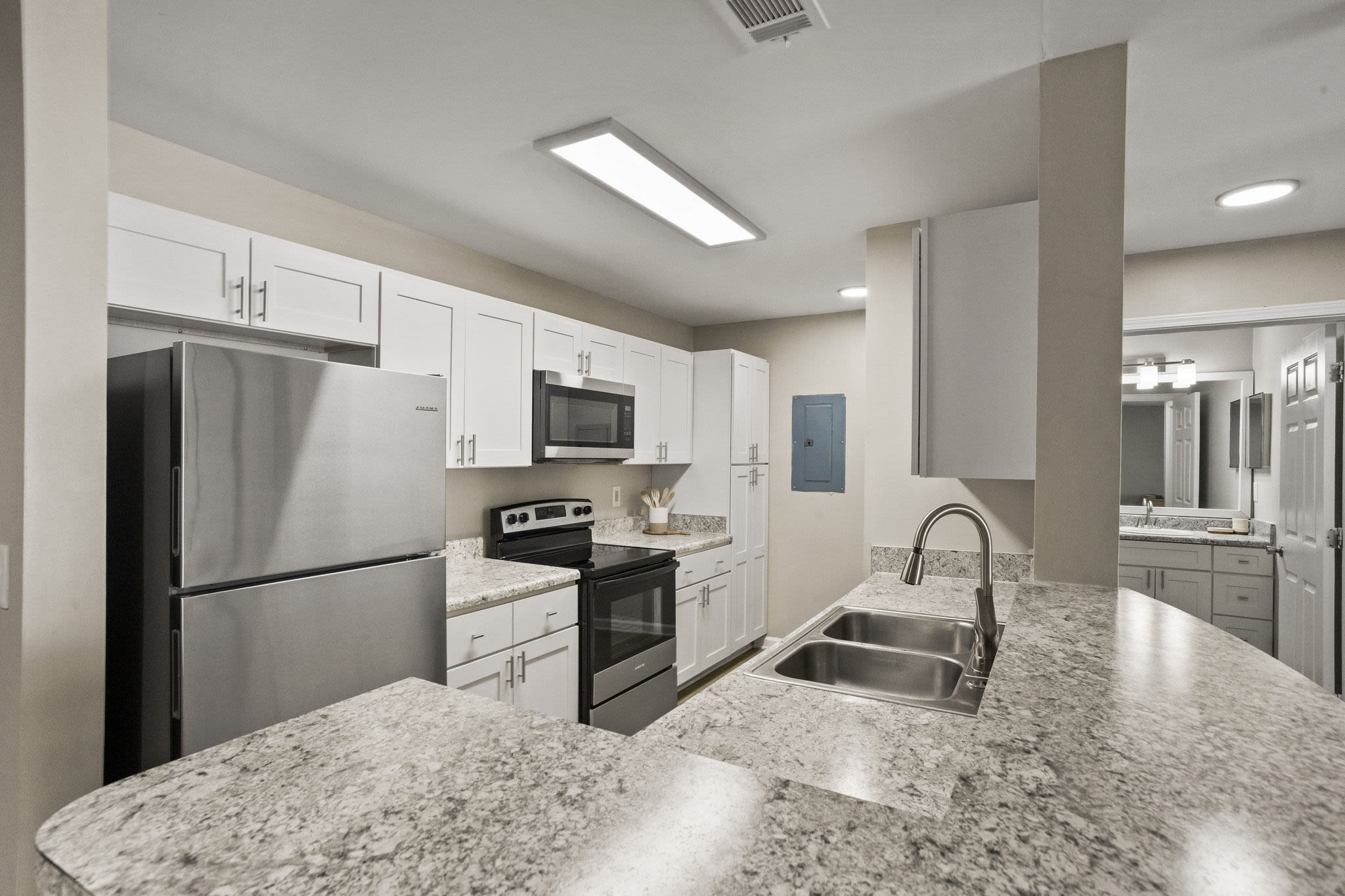 Kitchen with wooden cabinets at The George Apartment Homes in Savannah, Georgia