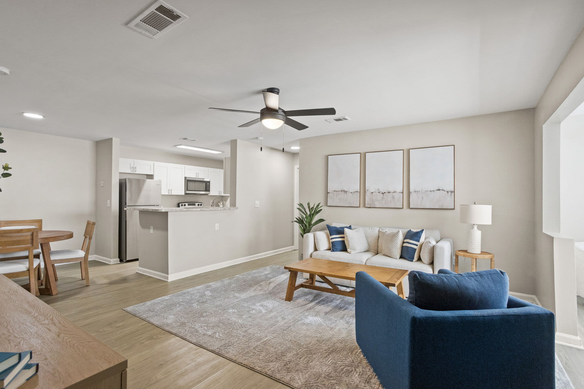 the-george-apartments-savannah-ga-renovated-apartment-living-room-with-hardwood-style-flooring-and-ceiling-fan