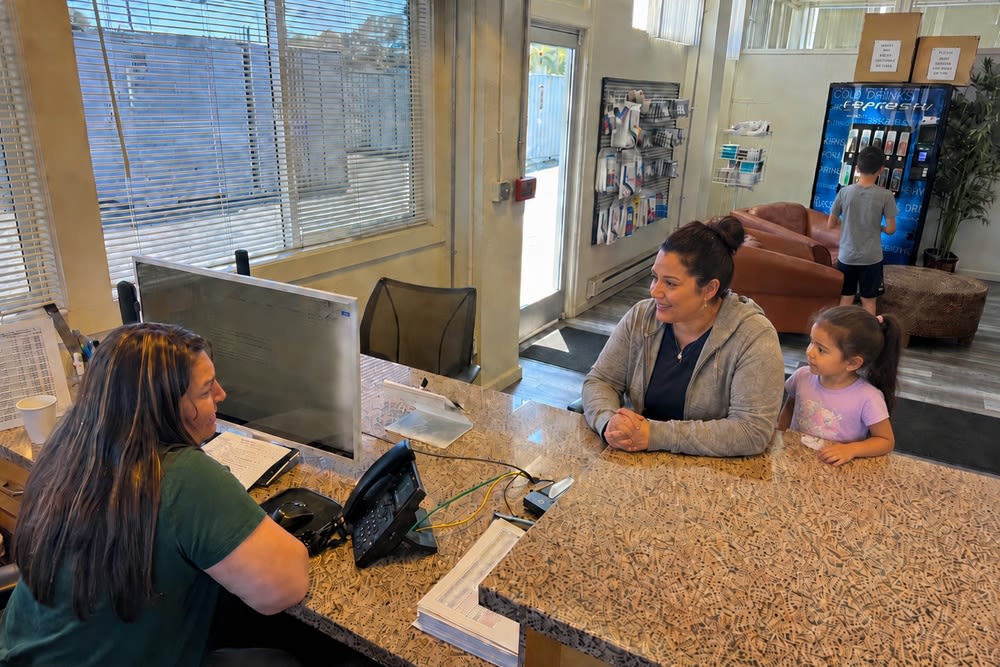 Office staff helping a customer compare storage options at CSI Mini Storage Richmond