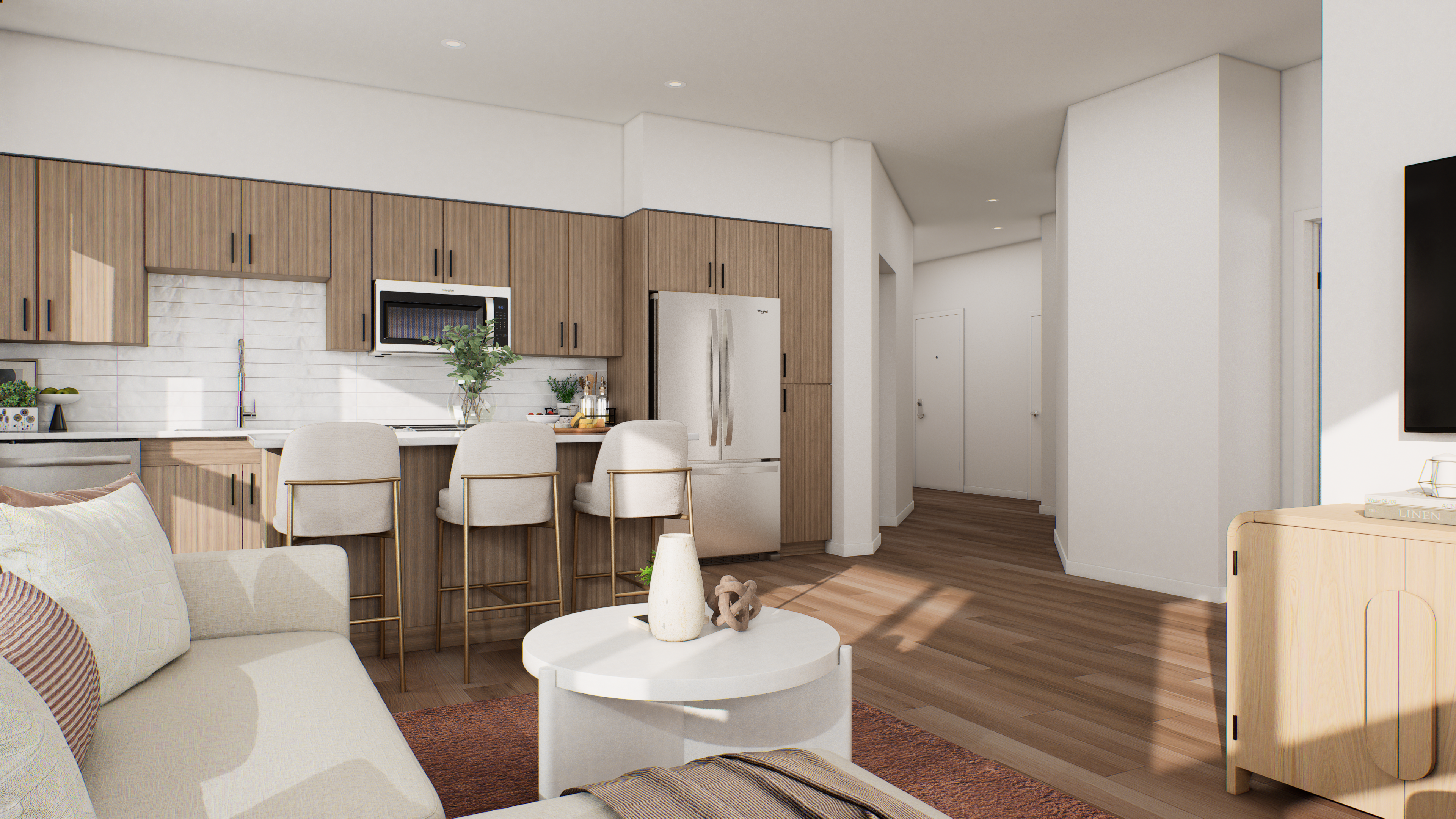 Living room looking into kitchen with light modern furniture at The Colton in Redwood City, California