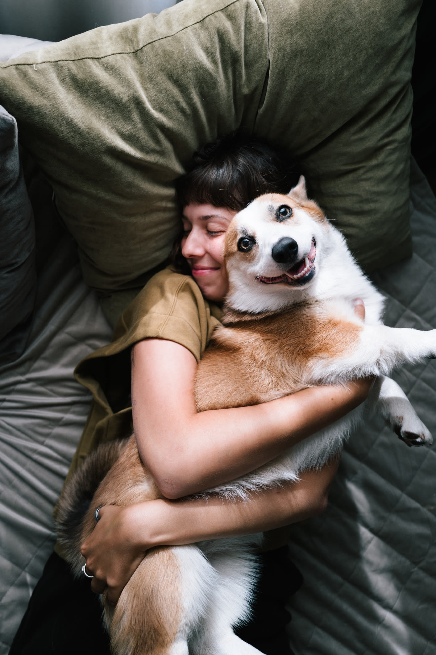 Woman snuggling with her dog at The Colton in Redwood City, California