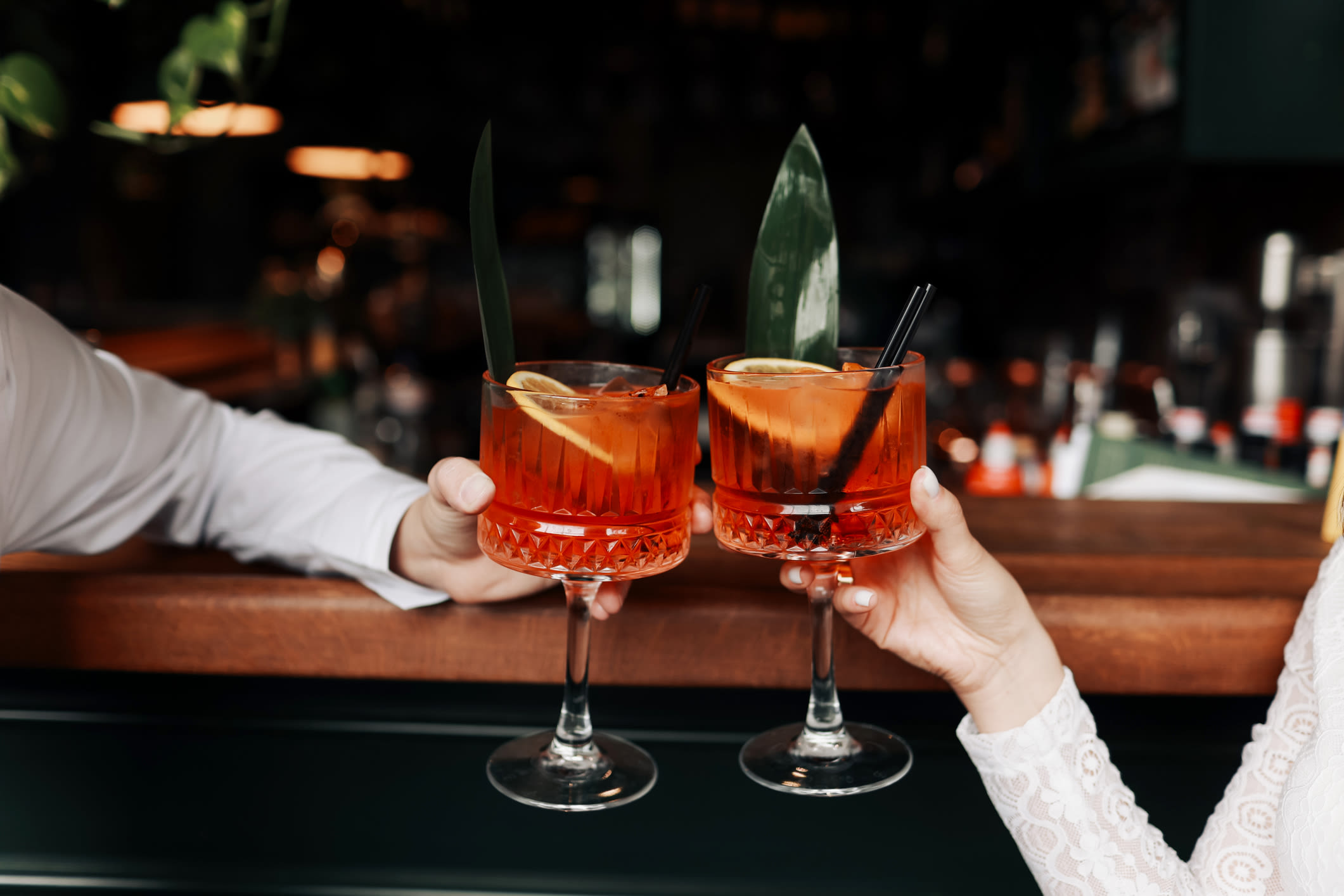 Residents holding two colorful drinks near The Colton in Redwood City, California