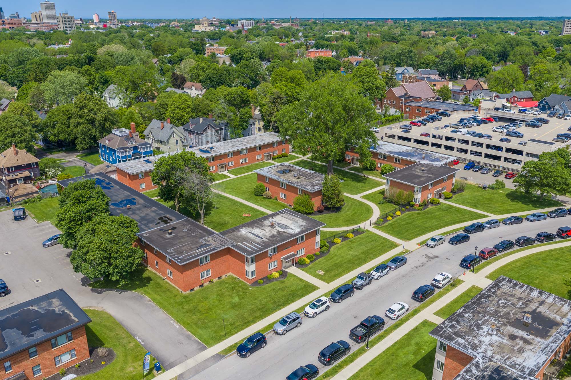 Landscaped apartment community and walkways at Highland Manor Apartments in Rochester, New York