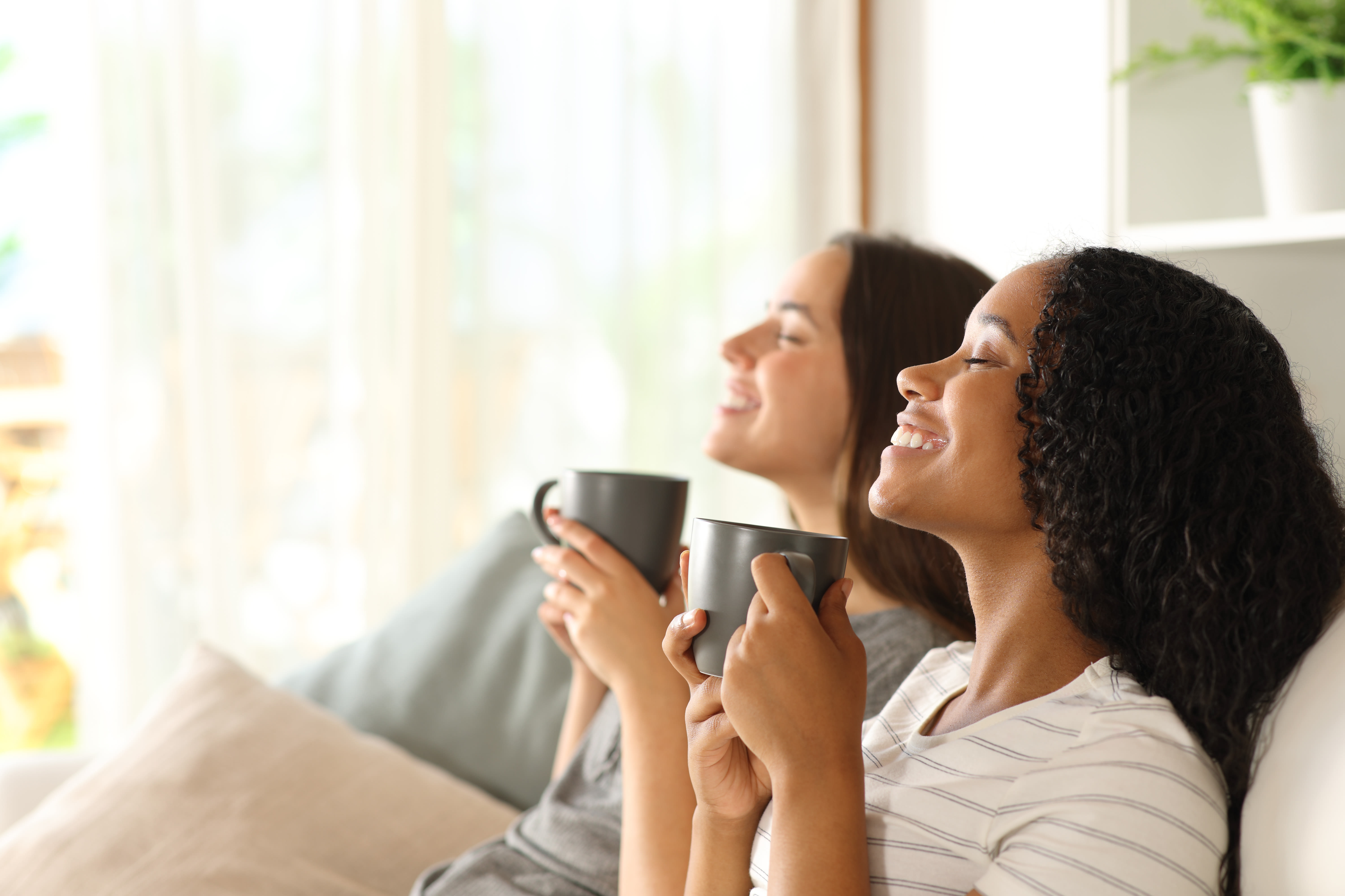 Residents enjoying a relaxing morning indoors with natural light at Pinnacle at Afton in Richmond, Virginia 