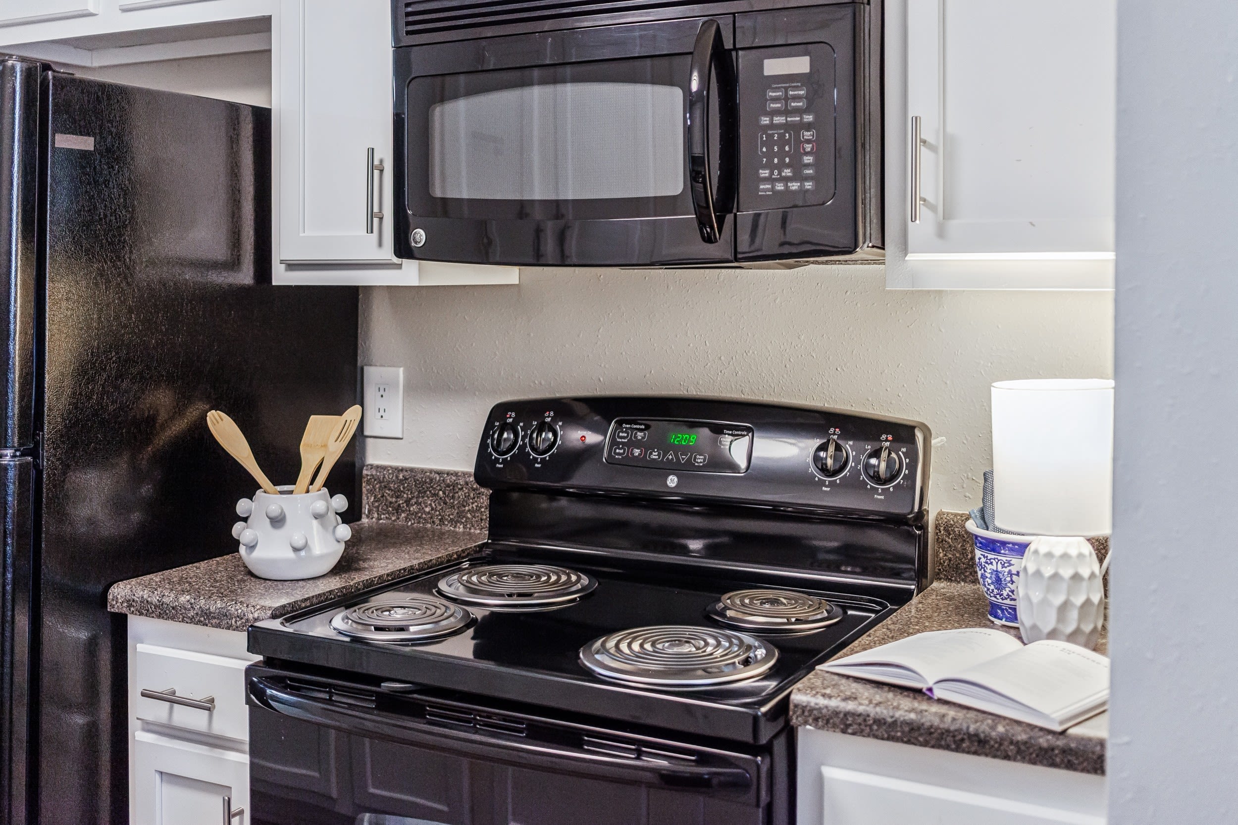 Modern kitchen with black appliances at Reserve South in Richmond, Virginia