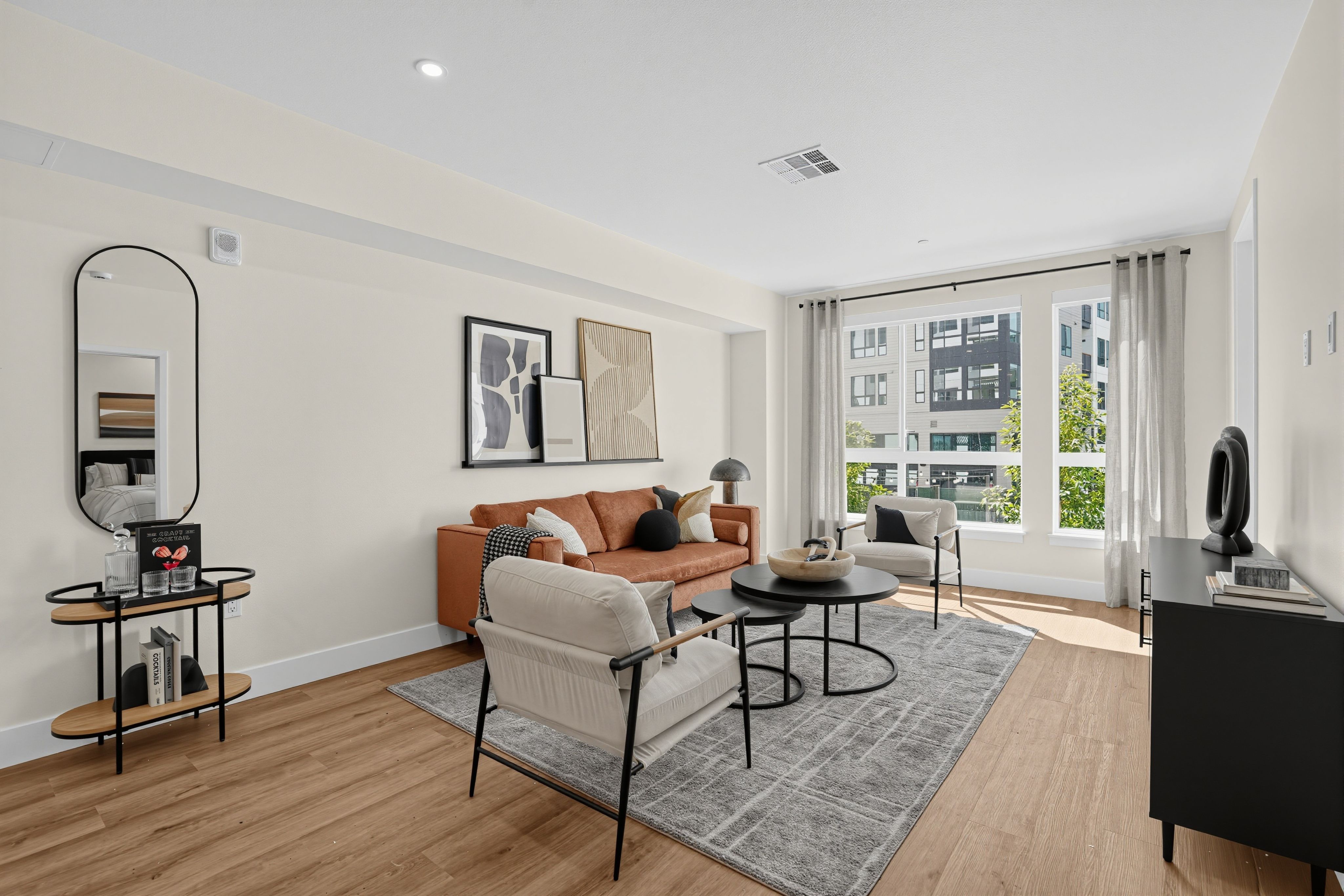 Living room with door to outside and modern furniture at The Colton in Redwood City, California