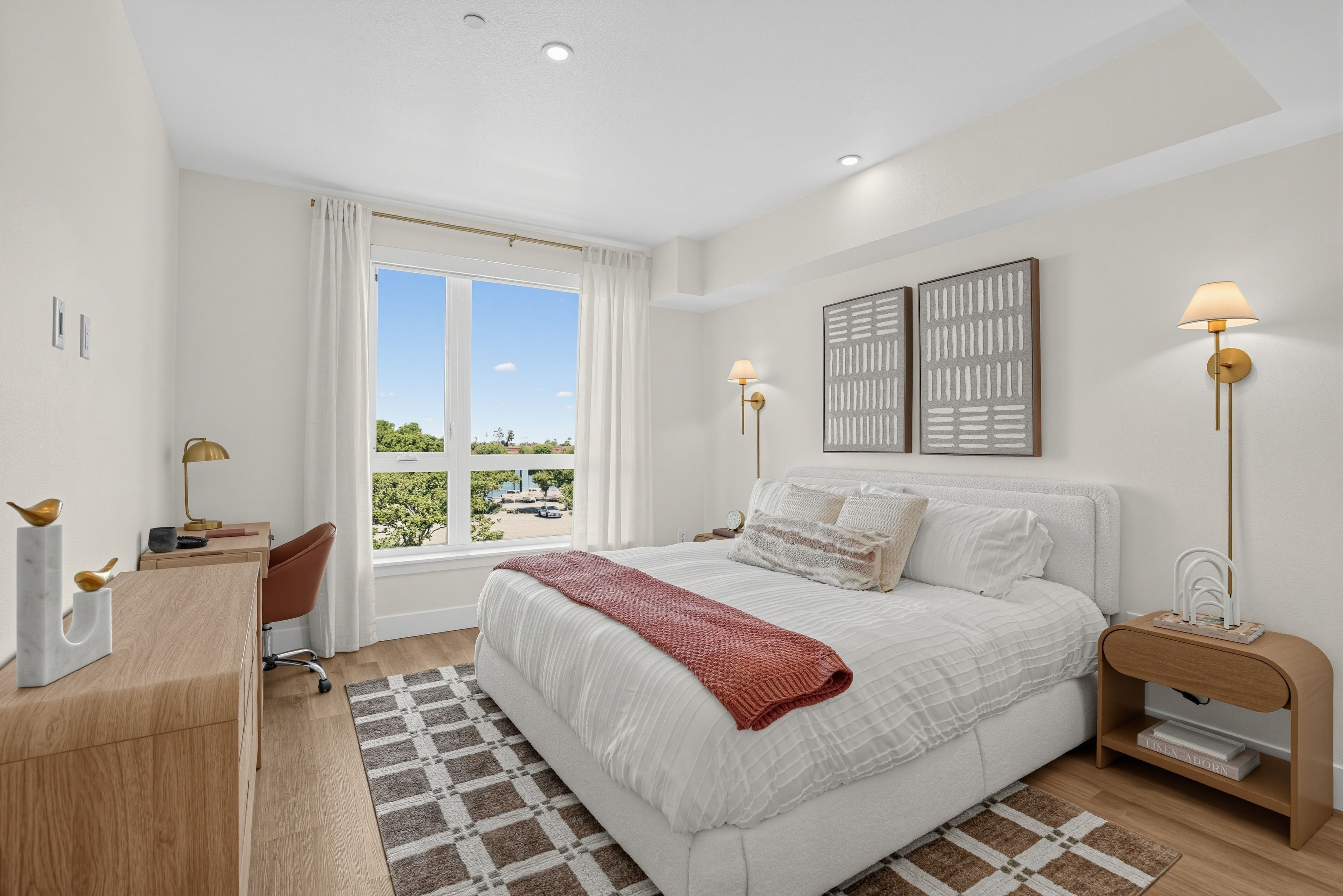 Bedroom with a large window, modern furnishings and a house plant at The Colton in Redwood City, California