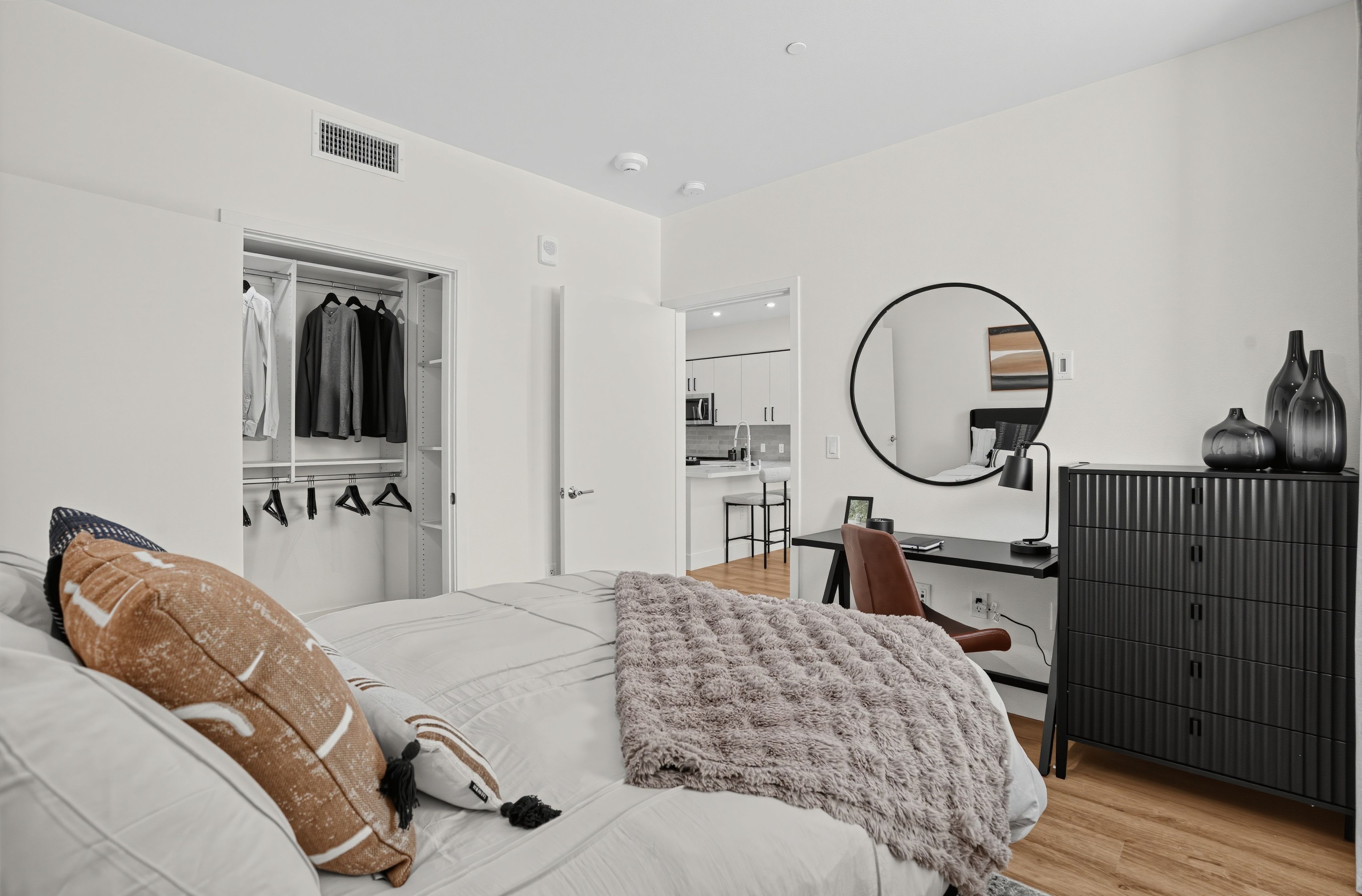 Large bedroom with modern furniture and a large window at The Colton in Redwood City, California