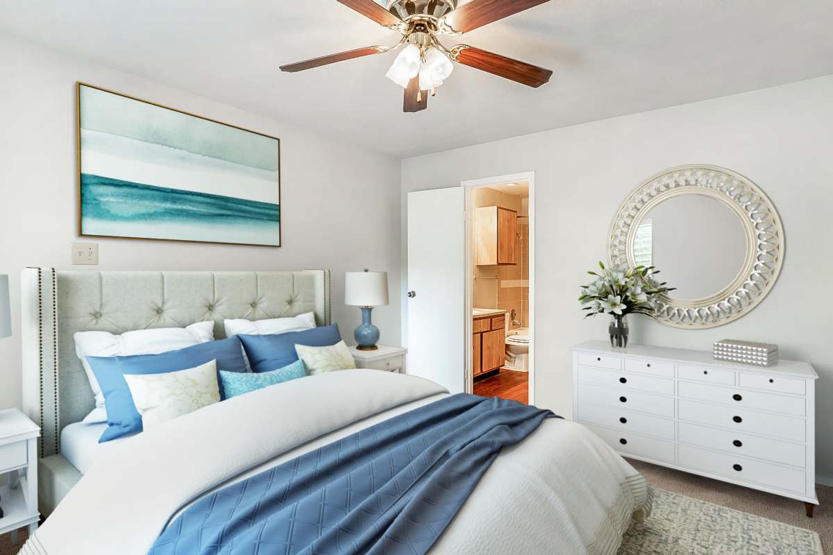 Model bedroom with ceiling fan at Whispering Creek Villas, San Antonio, Texas
