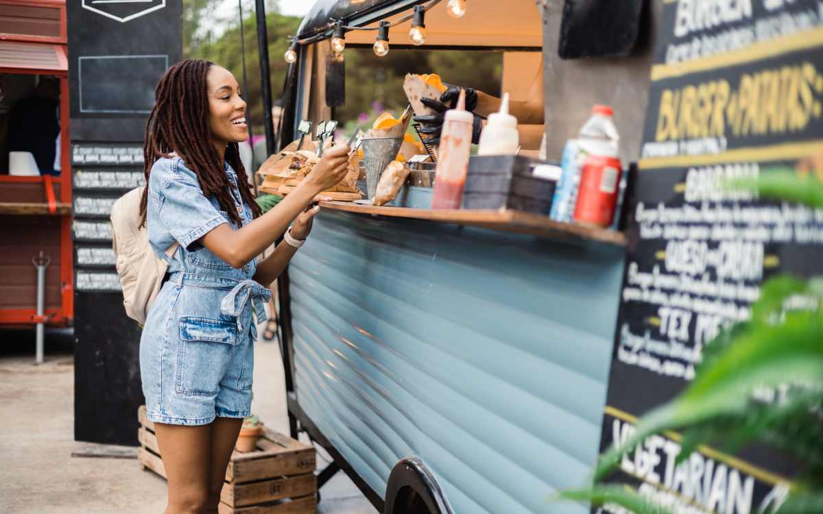 Resident eating lunch at a food truck near Highland Manor Apartments in Rochester, New York