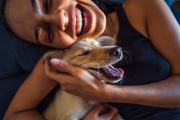 Happy resident and her pup at Stone Ranch Townhomes in Seguin, Texas