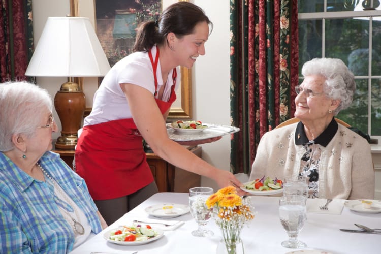 residents being served a salad at Traditions of Cross Keys in Glassboro, New Jersey