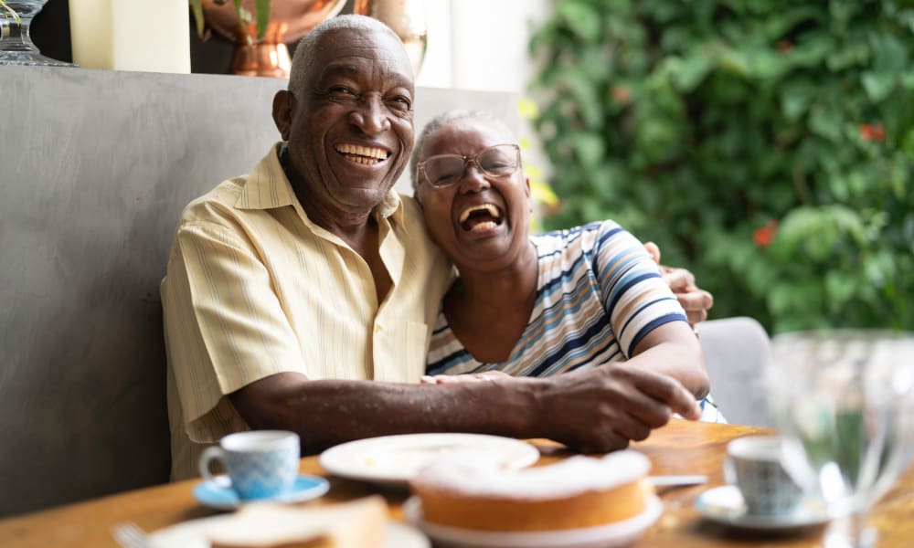 Resident couple hugging at a table in Governor's Village in Mayfield Village, Ohio