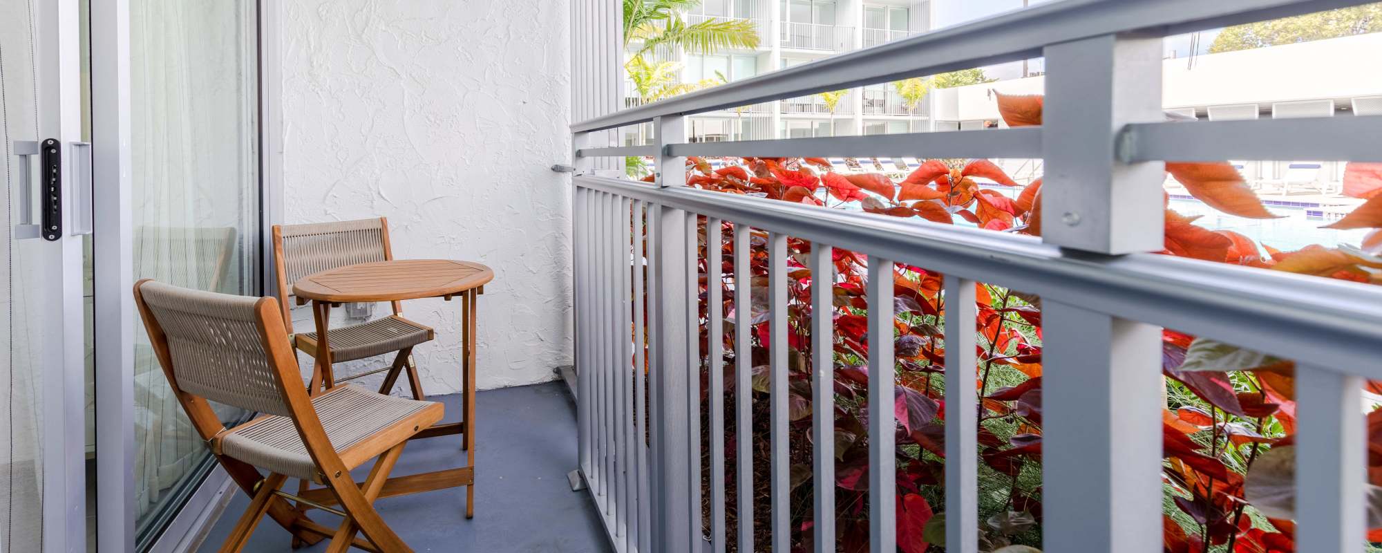 Private balcony with chair and tea table at  Alture Westland in Hialeah, Florida