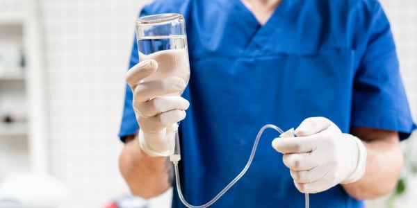 Nurse setting up an IV for a resident in hospice care at Retirement Ranch in Clovis, New Mexico