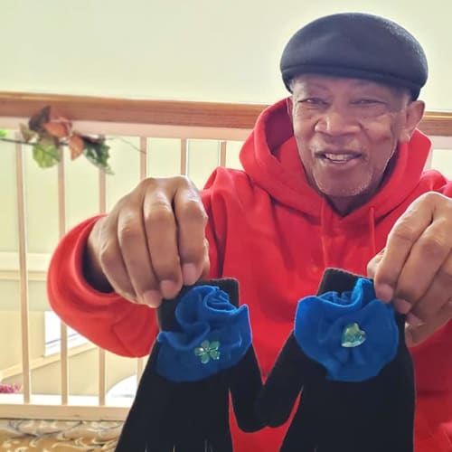Resident holding up a pair of winter gloves at FountainBrook in Midwest City, Oklahoma
