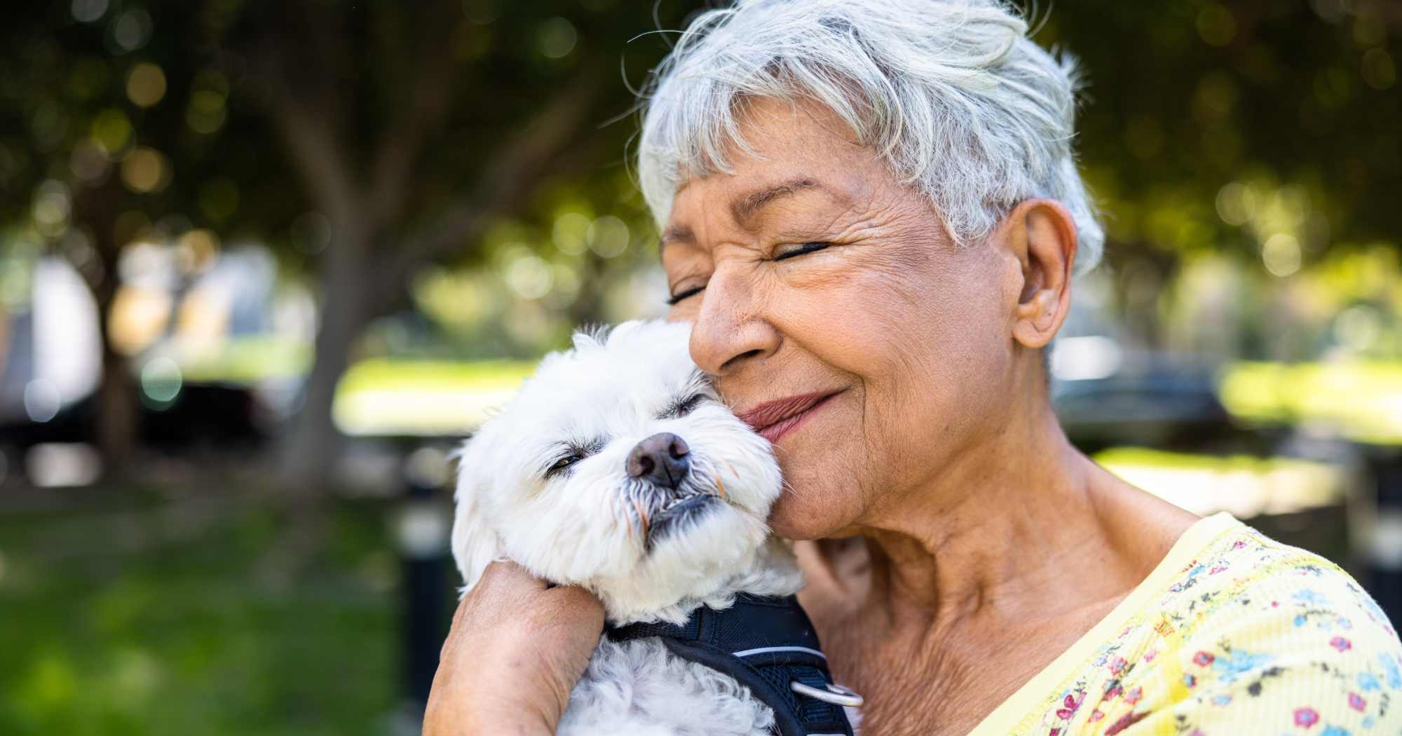 Two residents walking their dog at Clearwater at The Arboretum in Austin, Texas