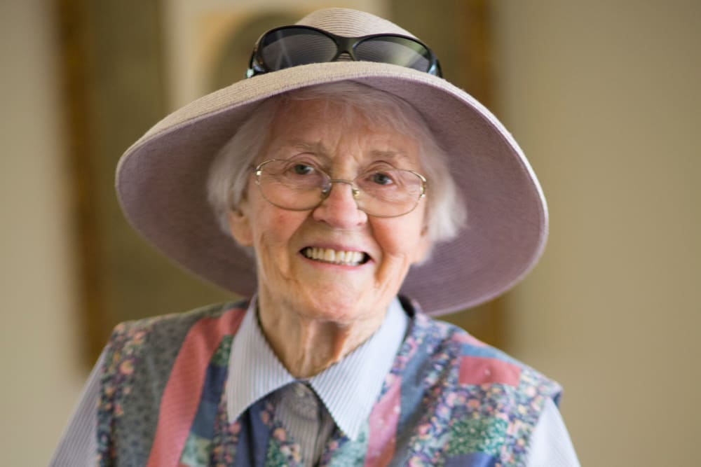 A smiling resident with a hat at Gables of Ojai in Ojai, California