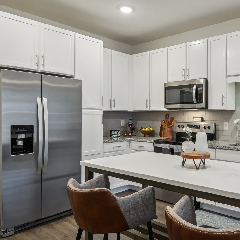 An apartment kitchen and dining room table and chairs at Novo Westlake in Jacksonville, Florida