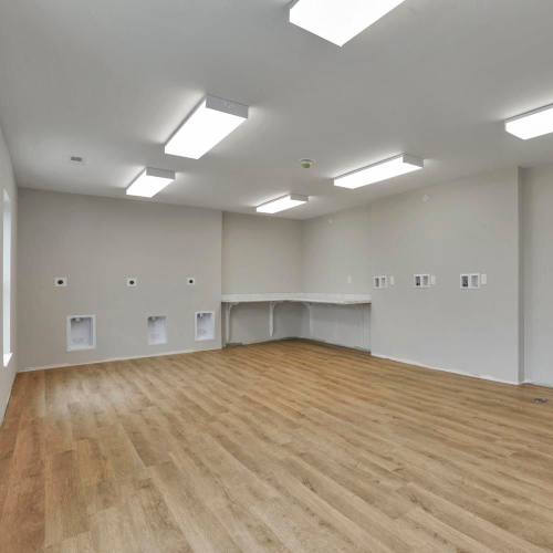 Empty room with wooden floor and bright lights at The Lofts On First in The Plains, Ohio