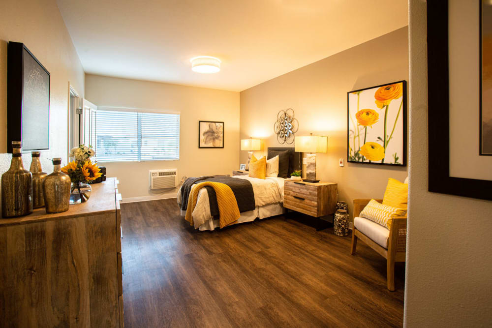 Resident bedroom with hardwood floors at Carefield Pleasanton in Pleasanton, California