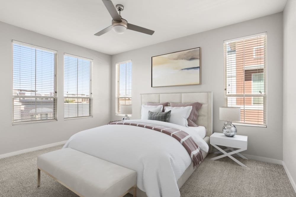 Bedroom with plush carpeting in a model home at Town Commons in Gilbert, Arizona