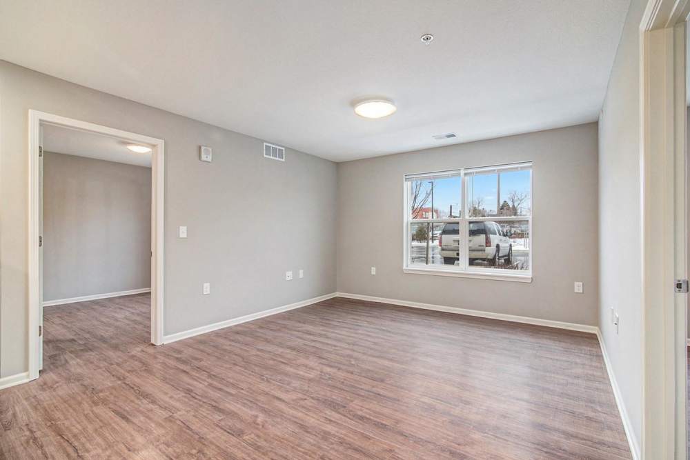 Open layout living space with wood-style flooring and large window for natural light at Ruth Park in Traverse City, Michigan