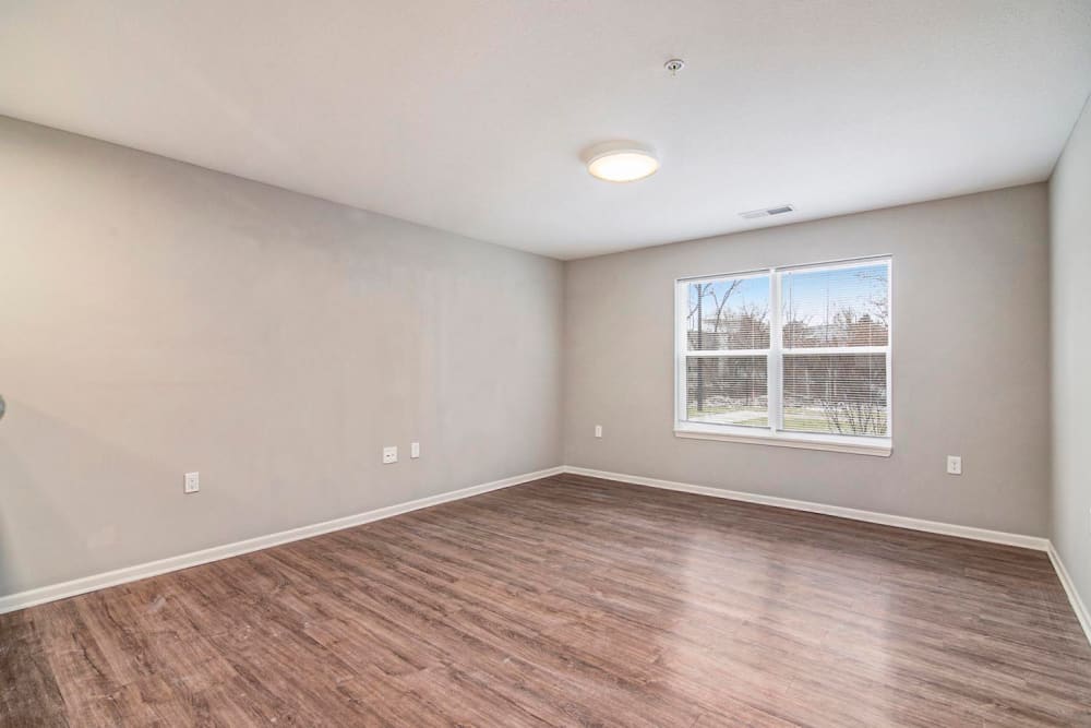 Spacious living area with wood-style flooring and large windows for natural light at Ruth Park in Traverse City, Michigan