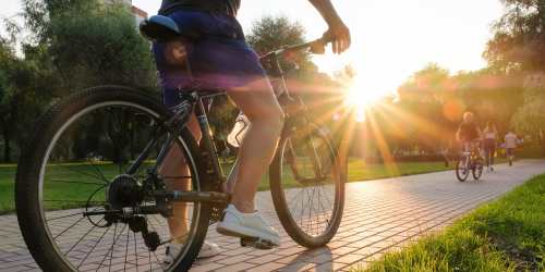 Resident biking on a path near Mountain Breeze Villas in San Bernardino, California