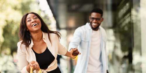 A happy couple exploring around near Jefferson Cunningham Apartments in Los Angeles, California