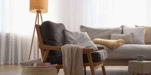 Living room with a sofa and lamp at Rancho Niguel Apartments in Laguna Hills, California