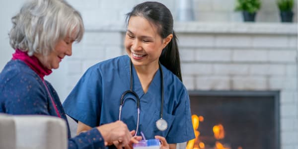 Resident with smiling caregiver at Transitions At Home - Central in Stevens Point, Wisconsin