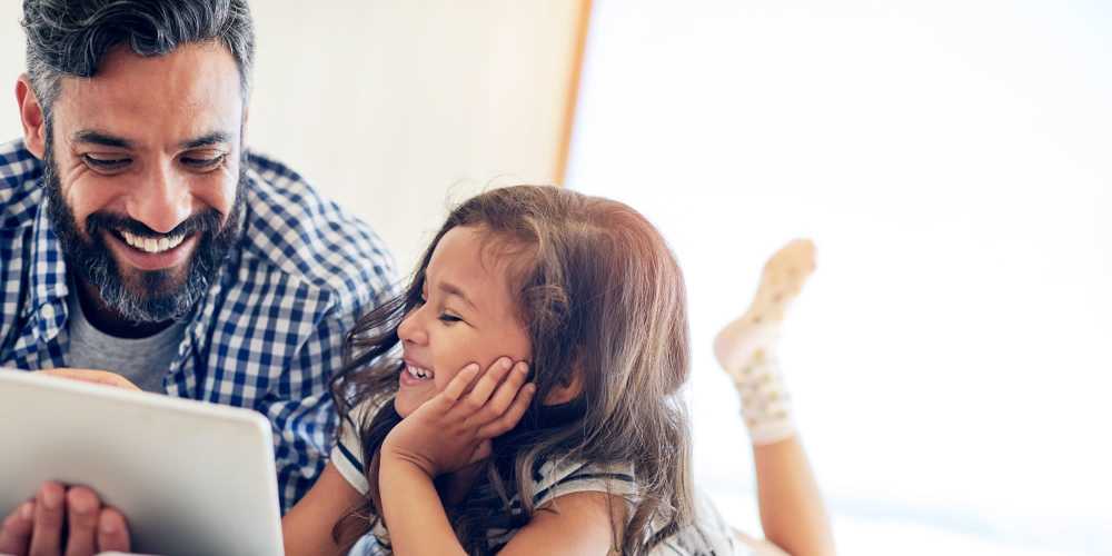 Father with his daughter reading story at 353 Main Street Family Apartments in Redwood City, California