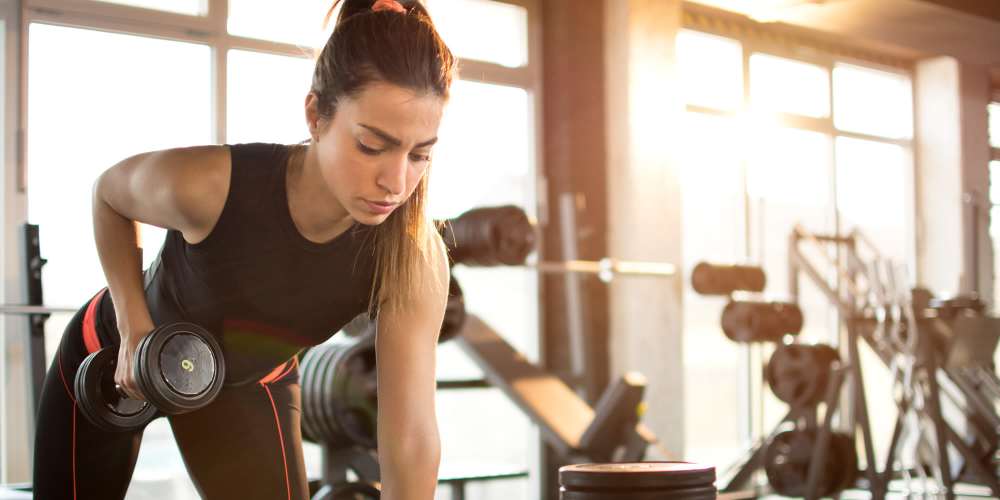 Woman doing workout in fitness center at Desert Meadows in Lancaster, California