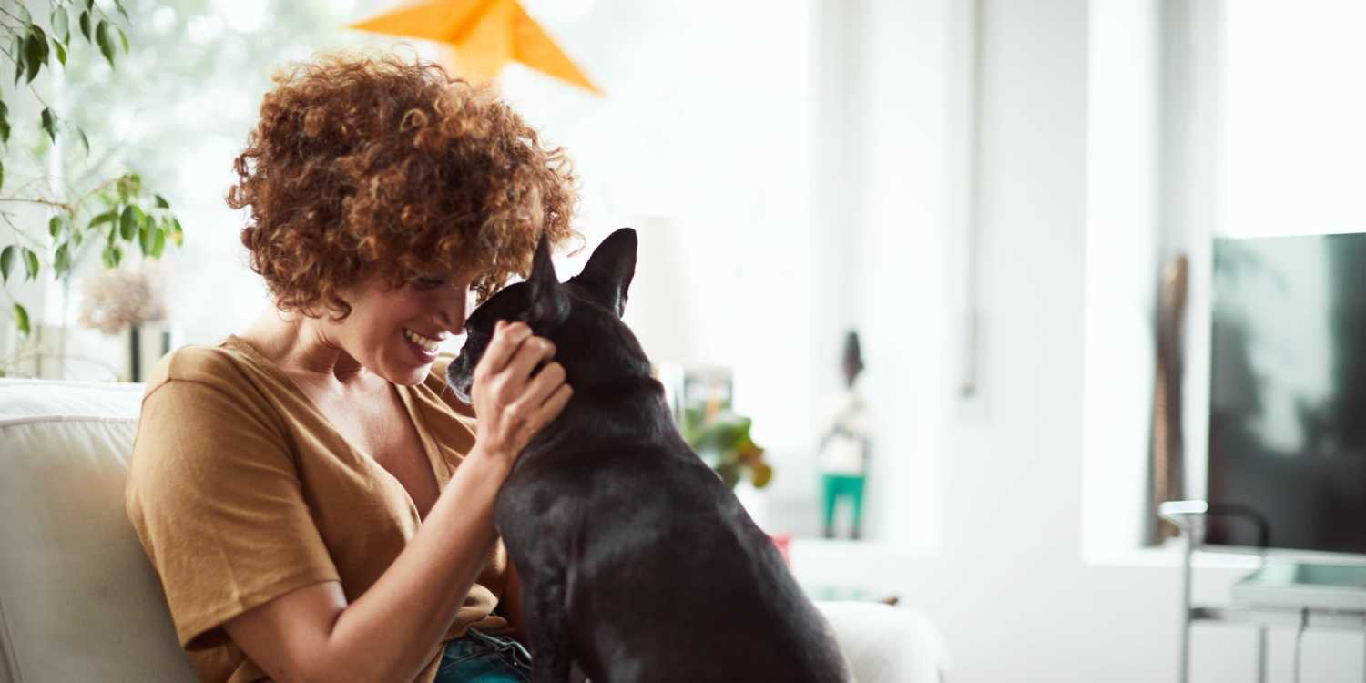 Resident cuddling her dog at Aspen Pines apartment homes in Wasilla, Alaska