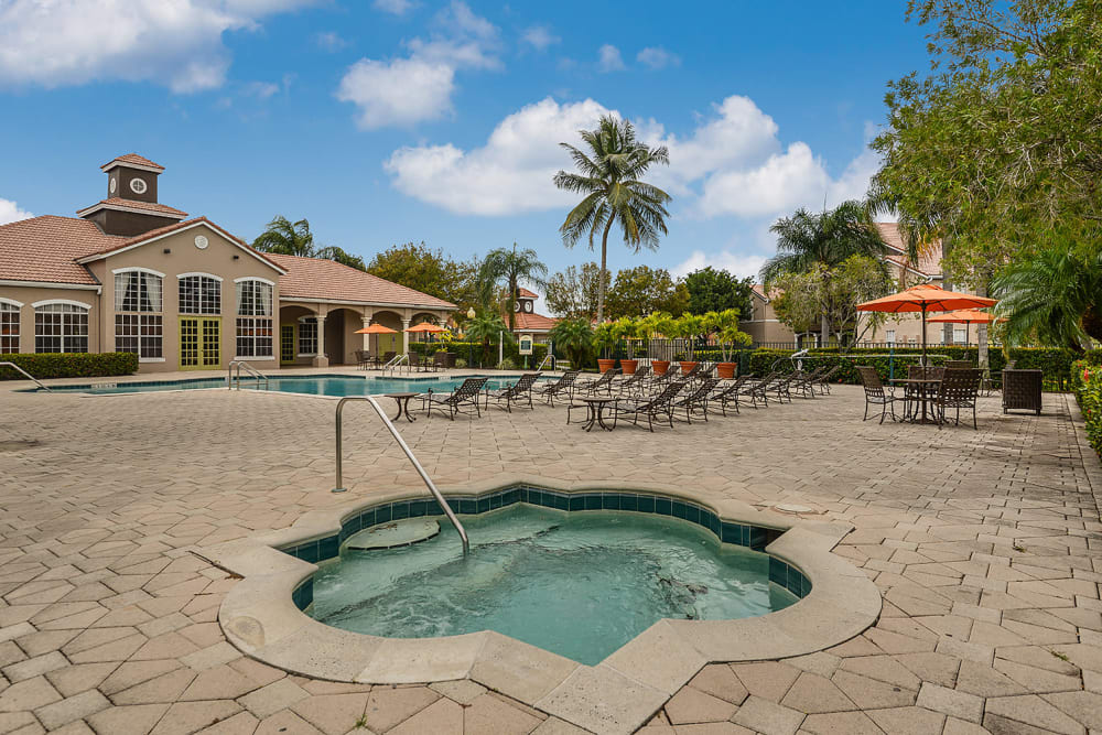 Hot tub and resort-style swimming pool at Royal St. George at the Villages Apartment Homes in West Palm Beach, Florida