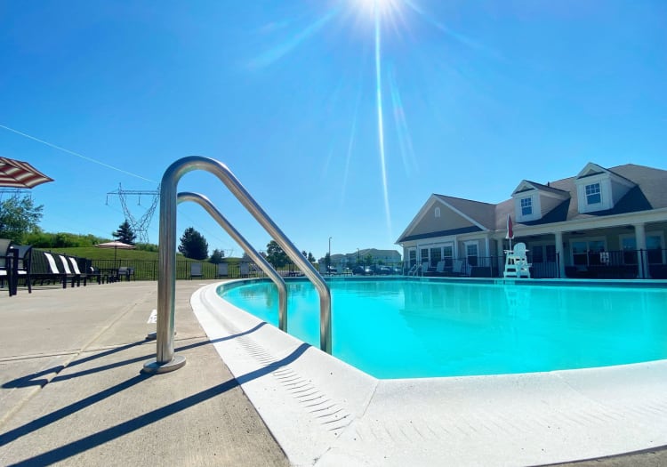 Swimming pool area on a beautiful day at Rivers Pointe Apartments in Liverpool, New York