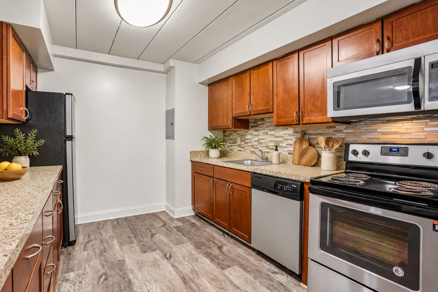 Contemporary kitchen with stainless-steel appliances at Stonegate at Devon Apartments in Devon, Pennsylvania