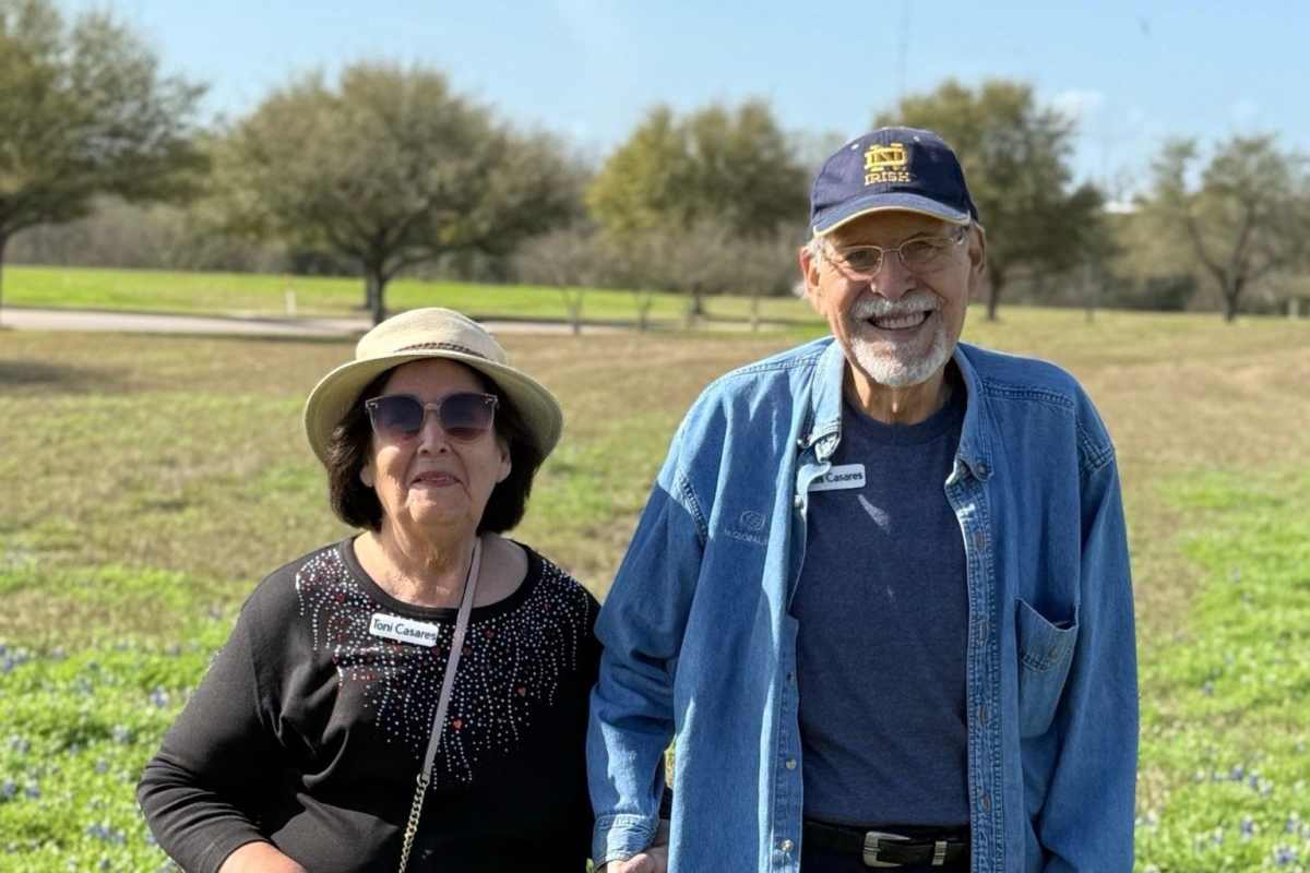 Residents smiling at a flower bed near Watercrest at Katy in Katy, Texas