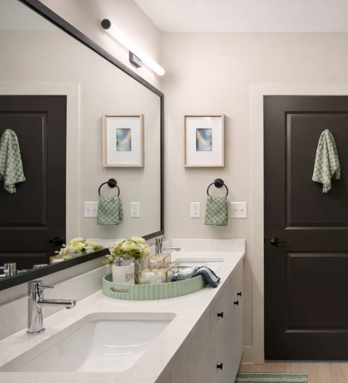 Dual vanity with large framed mirror at Cypress Point in Mooresville, North Carolina.