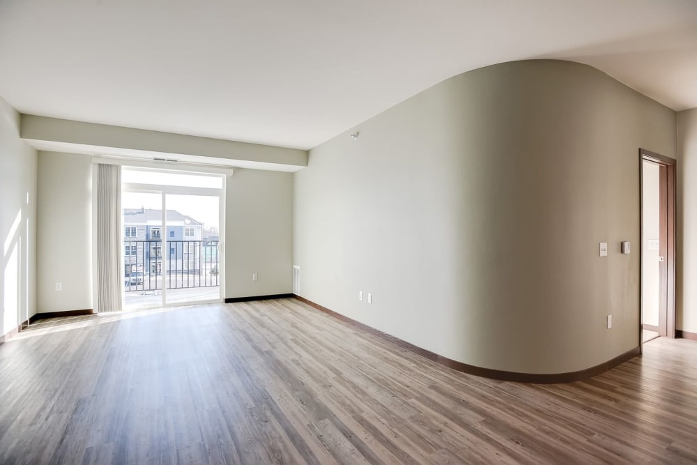 Spacious layout with wood-style flooring at Crossroads at Elm Creek in Maple Grove, Minnesota